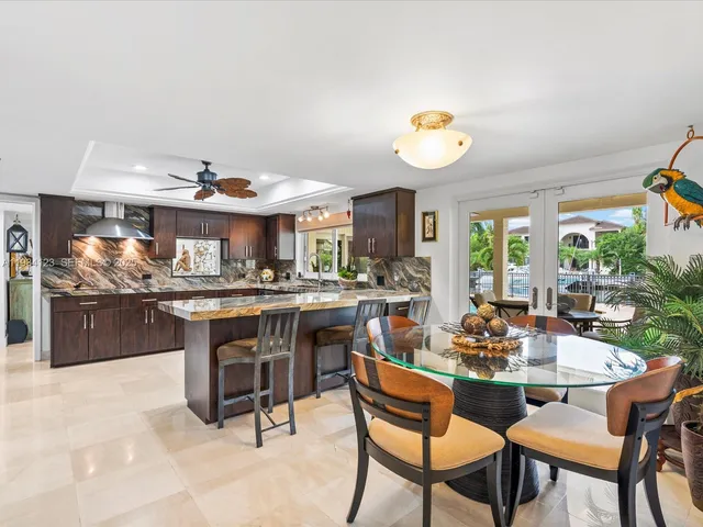 a view of a dining room and livingroom with furniture wooden floor and a rug