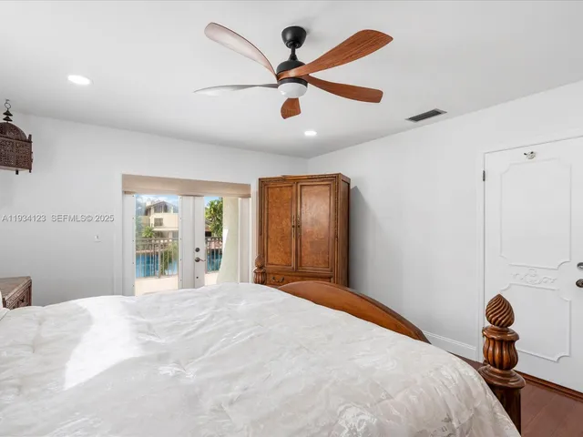 a bedroom with a bed and a large mirror