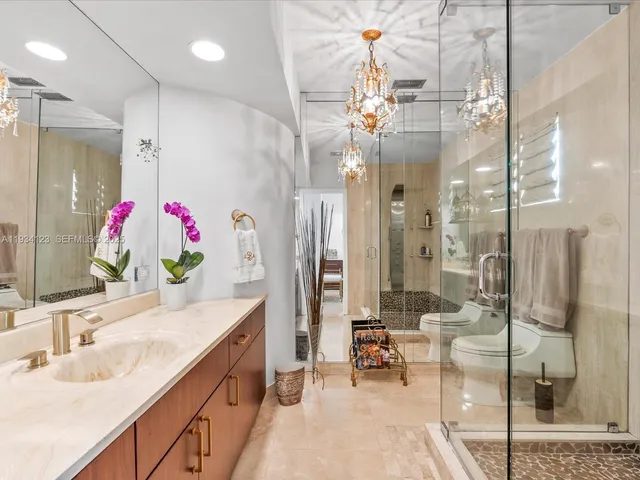 a bathroom with a double vanity sink mirror and shower