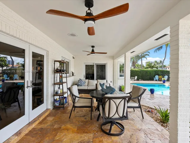 a dining room with furniture wooden floor a chandelier and a rug