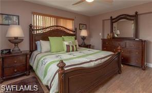 339 Landmark Street Marco Island, FL 34145 - Photo 11 of 18 a bedroom with a bed a mirror and dresser