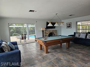 339 Landmark Street Marco Island, FL 34145 - Photo 12 of 18 a living room with furniture and a fireplace