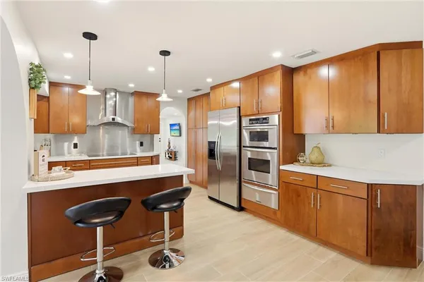 a large kitchen with a table and chairs