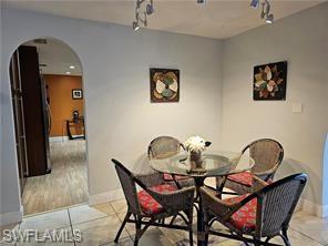 339 Landmark Street Marco Island, FL 34145 - Photo 16 of 18 a view of a dining room with furniture and chandelier