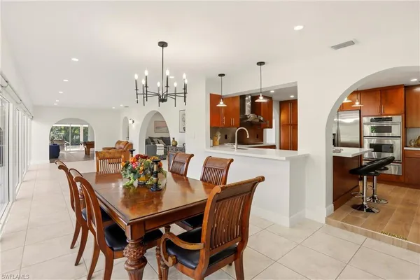a view of a dining room with furniture and chandelier