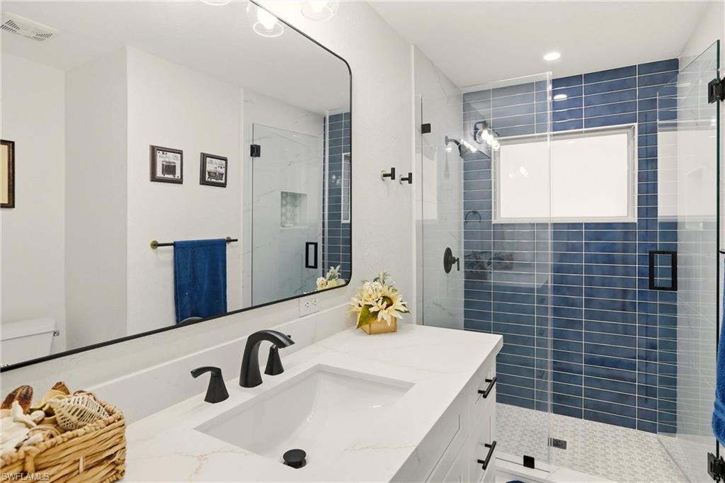 339 Landmark Street Marco Island, FL 34145 - Photo 22 of 49 a bathroom with a sink and a mirror