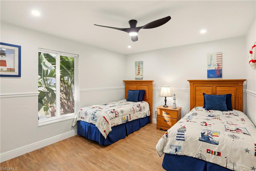 339 Landmark Street Marco Island, FL 34145 - Photo 23 of 49 a bedroom with two beds and a window