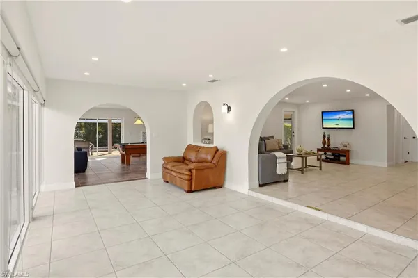 a lobby with furniture and a mirror