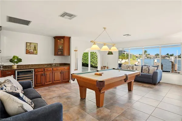 a living room with fireplace furniture and a large window