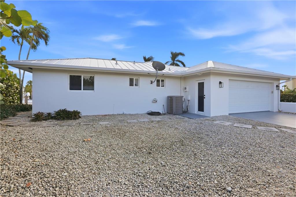339 Landmark Street Marco Island, FL 34145 - Photo 35 of 49 a view of a white house with a yard