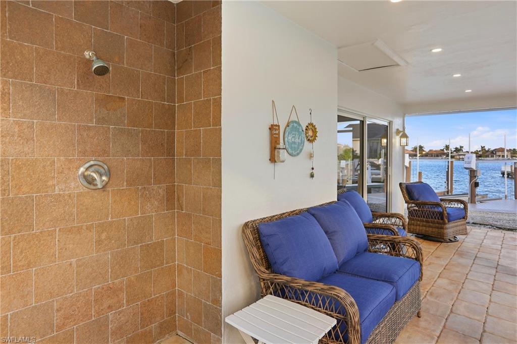 339 Landmark Street Marco Island, FL 34145 - Photo 38 of 49 a living room with furniture and a bathroom with a sink