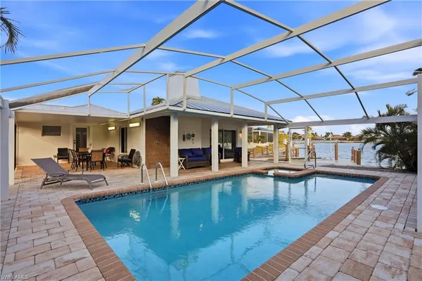 a view of a patio with swimming pool table and chairs
