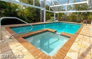 339 Landmark Street Marco Island, FL 34145 - Photo 4 of 18 a view of a swimming pool with a yard and sitting area