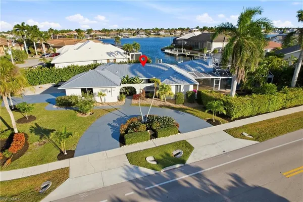 an aerial view of a house with yard swimming pool and outdoor seating