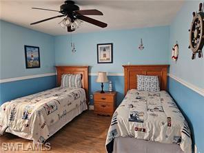339 Landmark Street Marco Island, FL 34145 - Photo 7 of 18 a bedroom with two beds and a chandelier