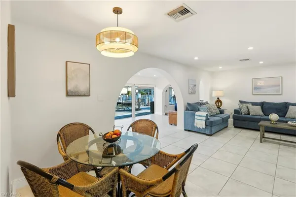 a view of a dining room with furniture and chandelier
