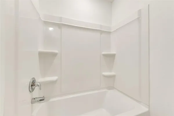 a bathroom with a bathtub and shower