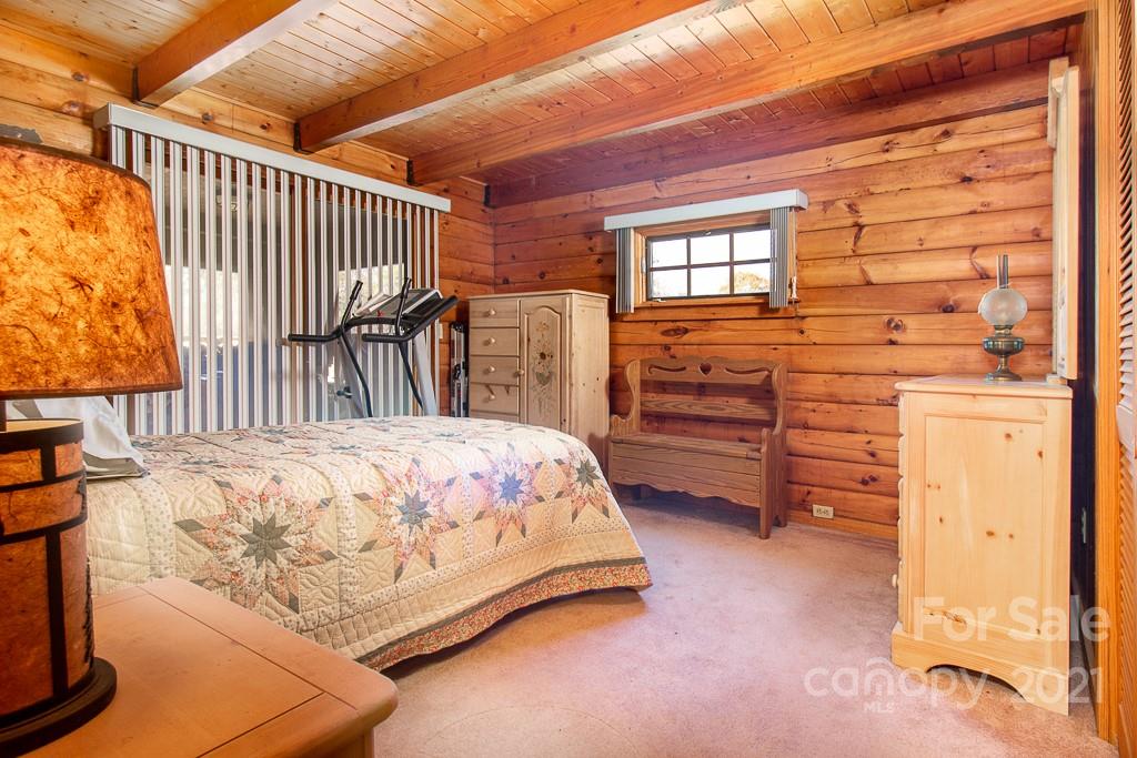620 Pioneer Ridge Road Canton, NC 28716 - Photo 13 of 42 a bed sitting in a bedroom next to a window