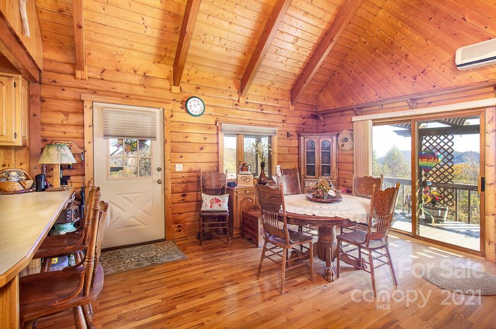 620 Pioneer Ridge Road Canton, NC 28716 - Photo 9 of 42 a view of a dining room with furniture window and wooden floor