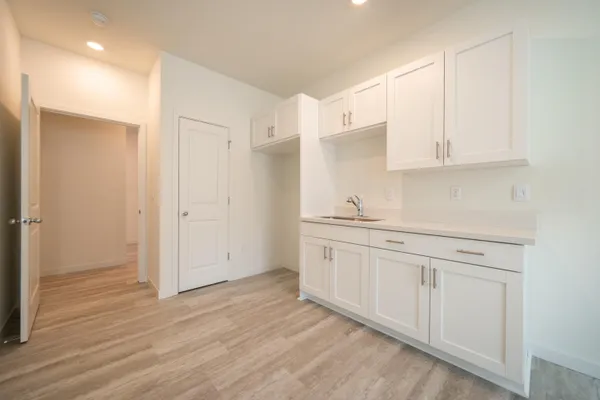 a view of a kitchen with white cabinets