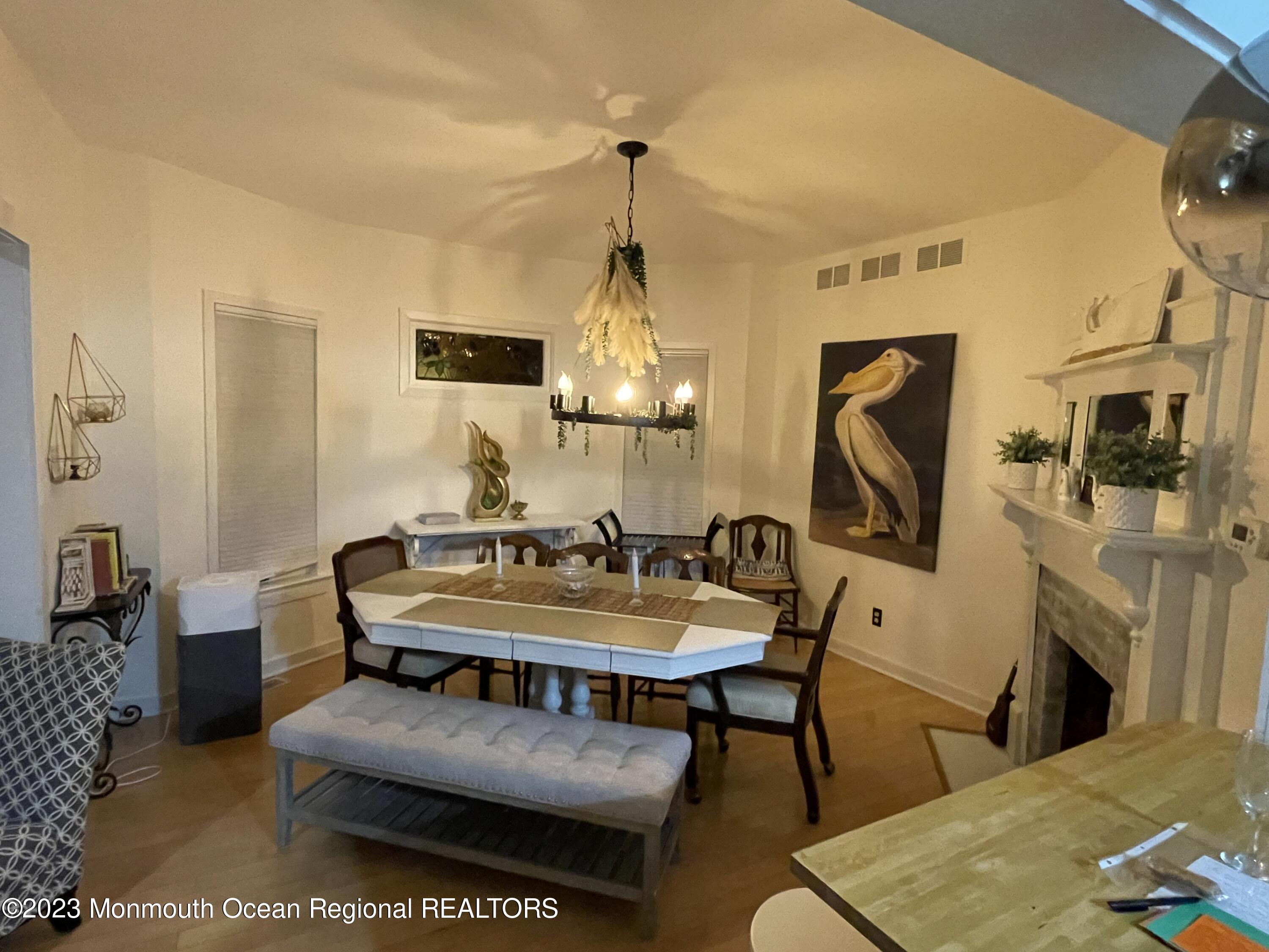 73 Cookman Avenue, Unit A Ocean Grove, NJ 07756 - Photo 11 of 20 a living room with furniture a fireplace and a flat screen tv