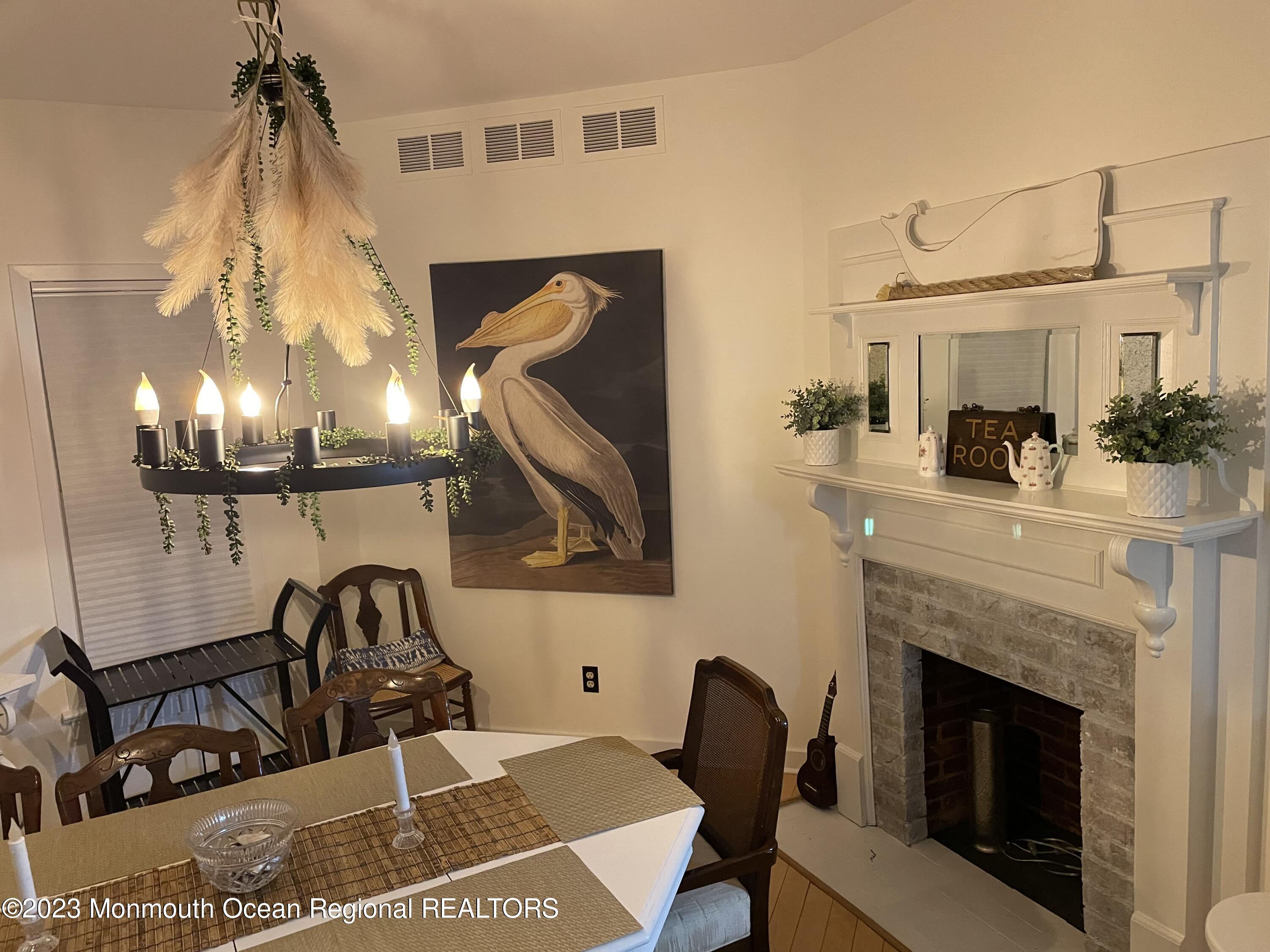 73 Cookman Avenue, Unit A Ocean Grove, NJ 07756 - Photo 12 of 20 a living room with furniture and a fireplace