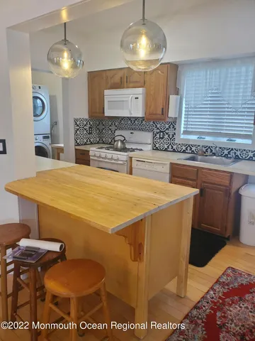 a spacious bathroom with a granite countertop sink and a mirror
