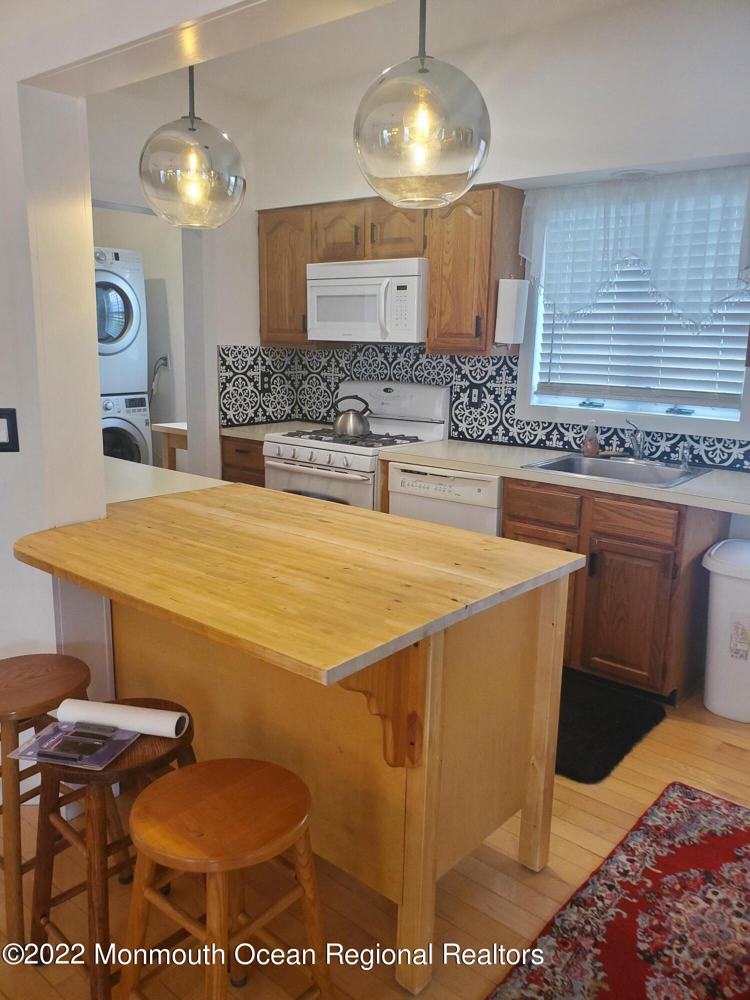73 Cookman Avenue, Unit A Ocean Grove, NJ 07756 - Photo 13 of 20 a spacious bathroom with a granite countertop sink and a mirror