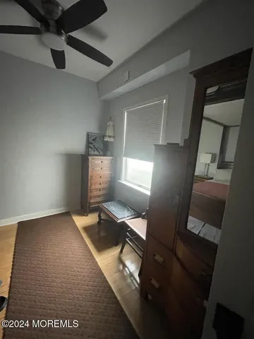 a view of a hallway to a livingroom with furniture
