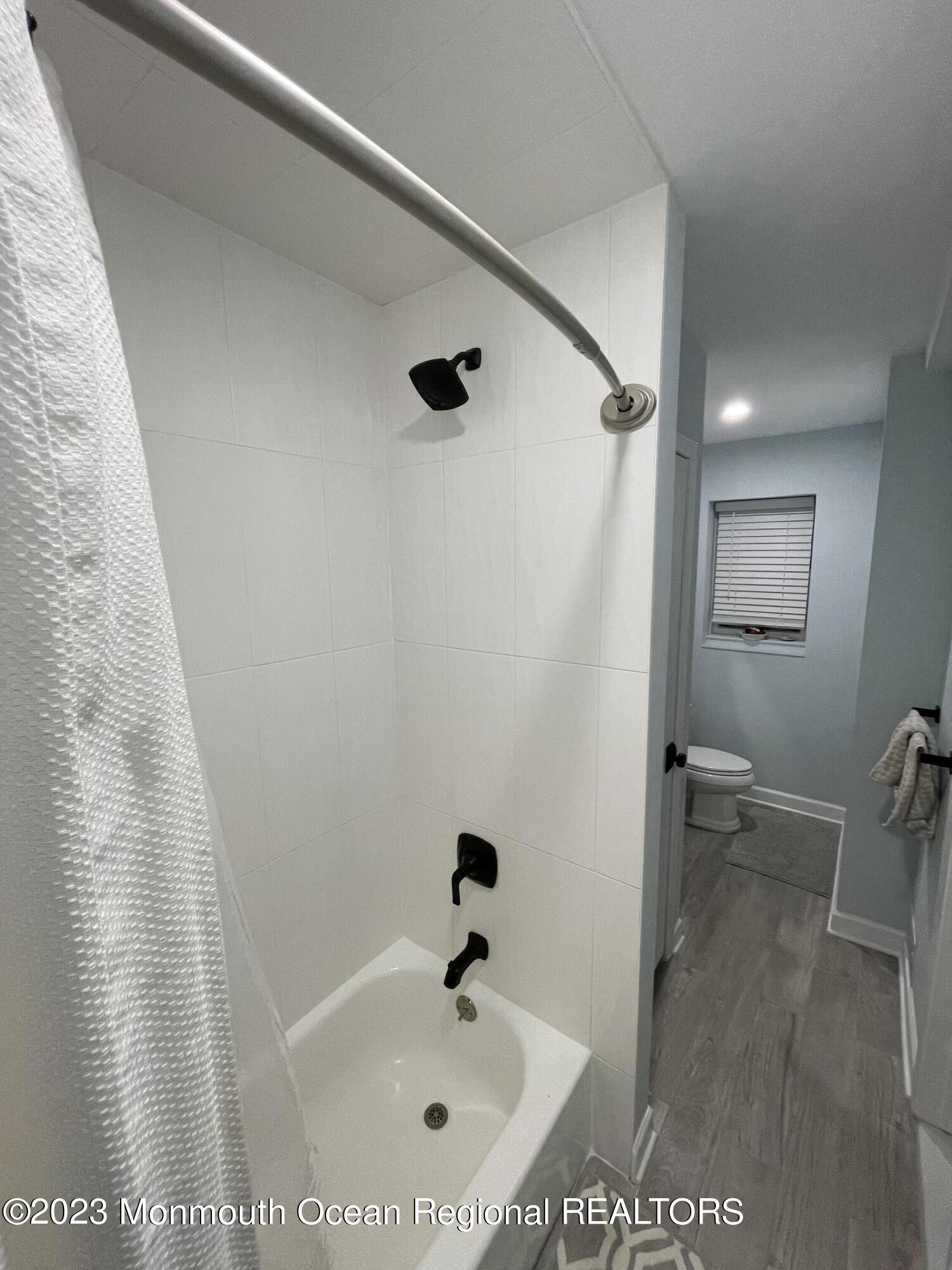 73 Cookman Avenue, Unit A Ocean Grove, NJ 07756 - Photo 18 of 20 a bathroom with a bathtub