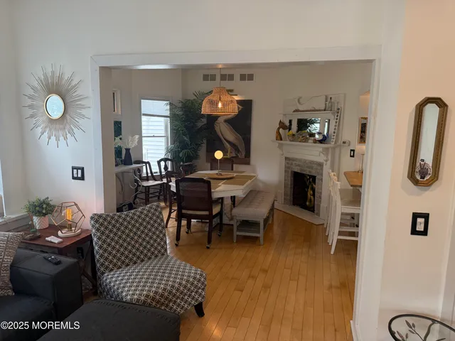 a living room with furniture a fireplace and a dining table