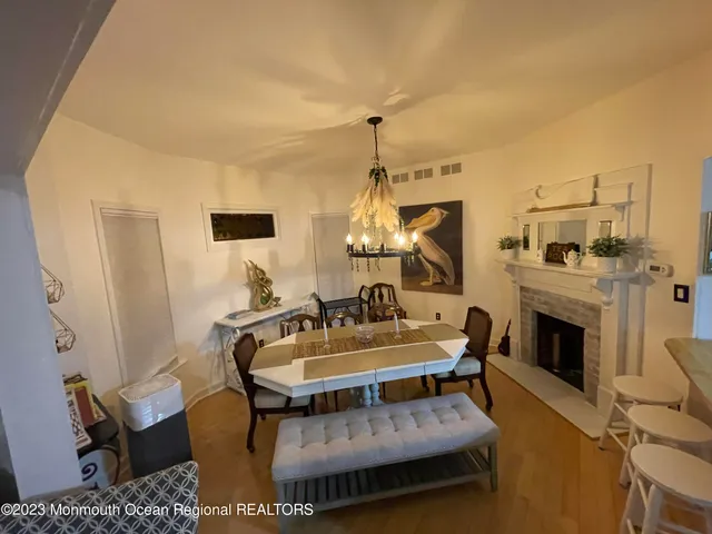 a living room with furniture a fireplace and a chandelier