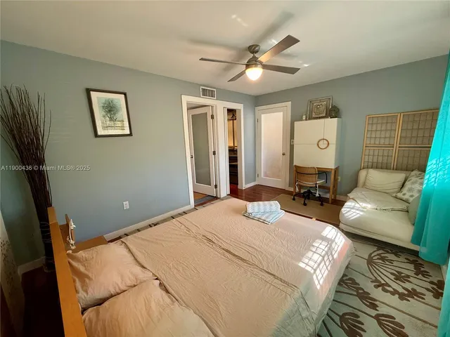 a bedroom with a bed couch and window
