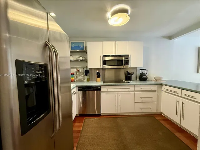 a kitchen with a sink stainless steel appliances and cabinets