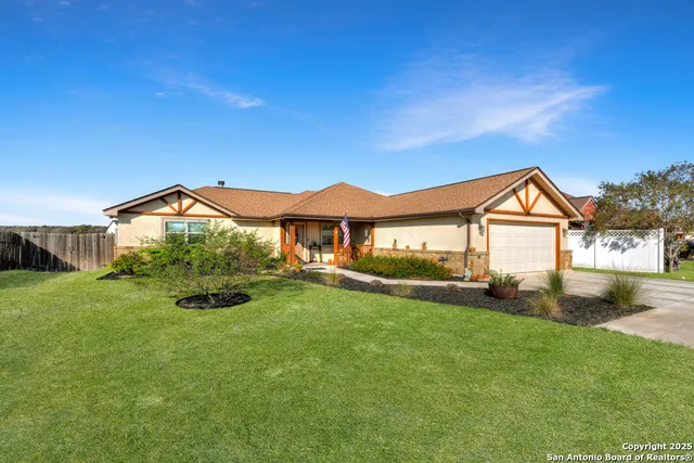 a view of house with yard and green space