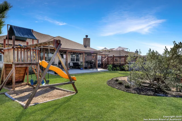 a view of a house with swimming pool and a yard