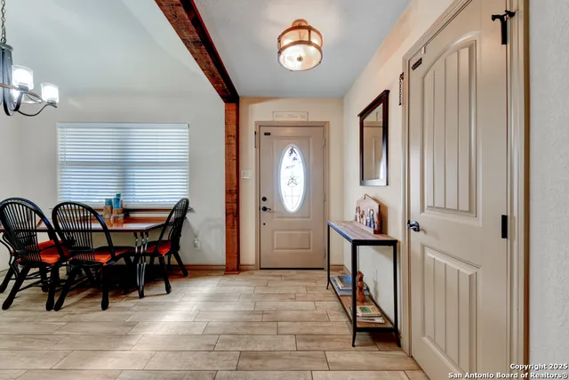 a view of a dining room with furniture and chandelier