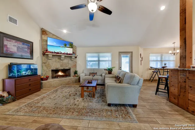 a living room with furniture and a fireplace