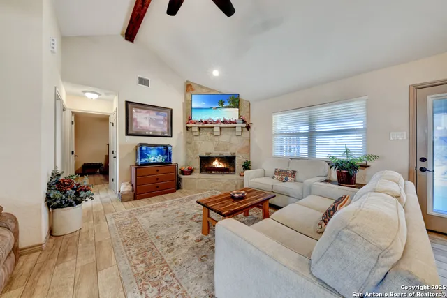 a living room with furniture and a fireplace