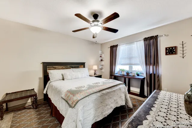 a bedroom with a bed and a table with a chandelier