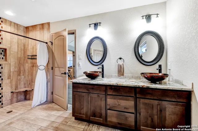 a bathroom with a double vanity sink and a mirror