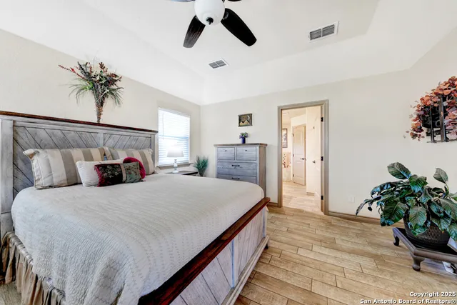 a bedroom with bed and a potted plant