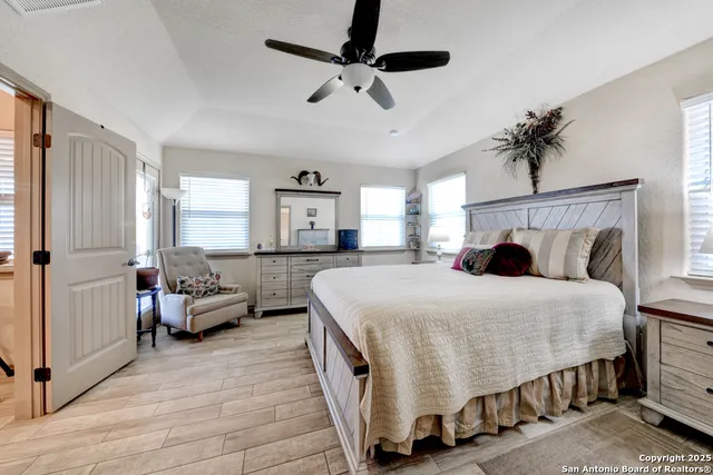 a bedroom with a bed and ceiling fan