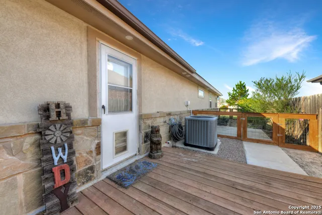 a view of a patio with wooden floor and a yard