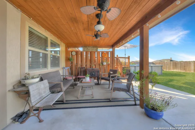 a dining room with furniture a rug and a large window