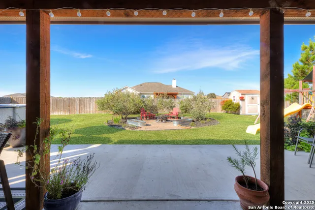 a view of a yard with an outdoor seating