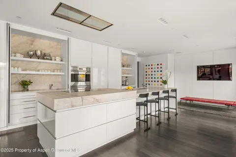 a large white kitchen with a large window