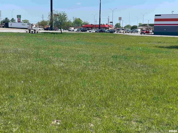 a view of a bench in the middle of a field