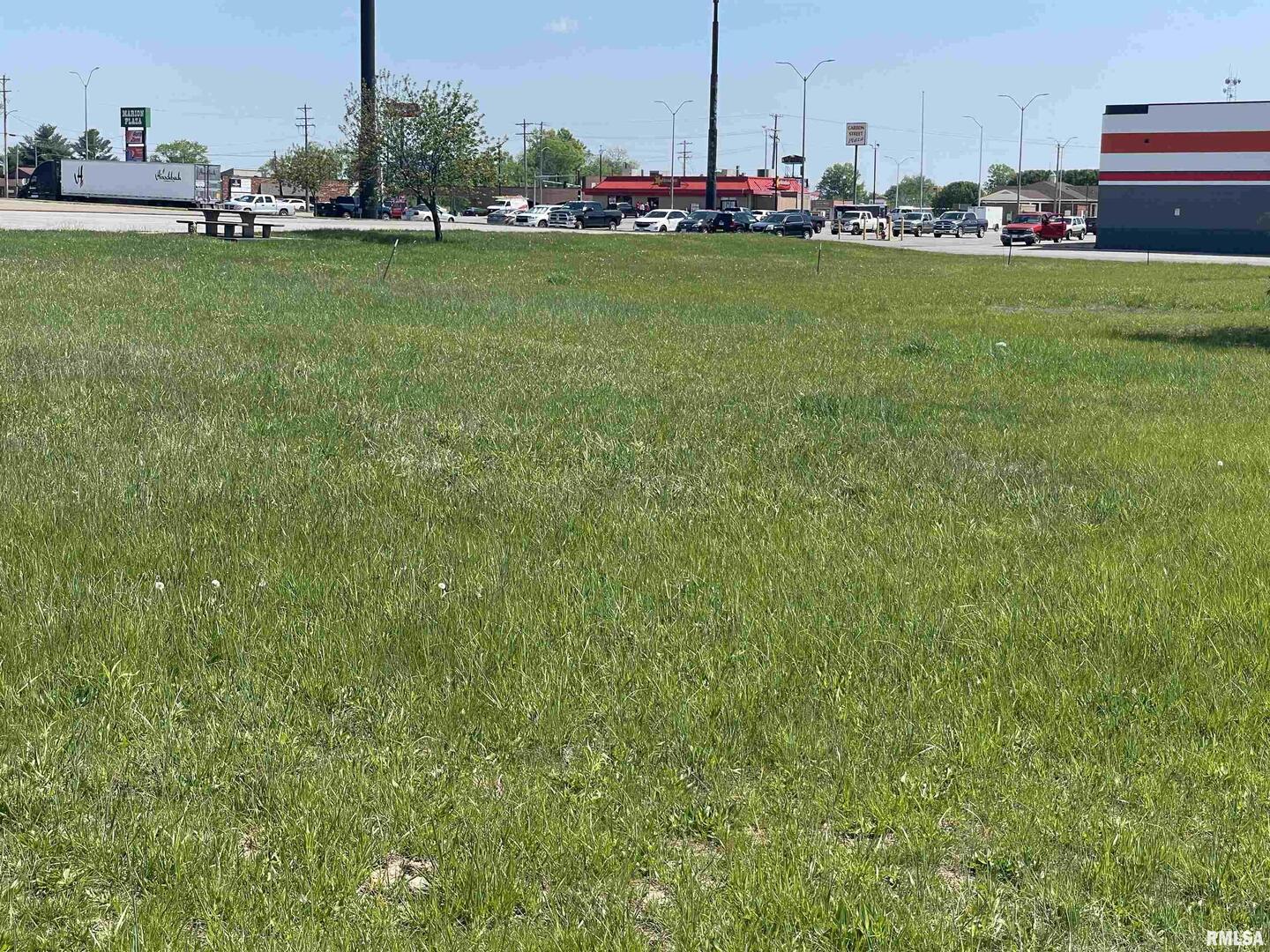 a view of a bench in the middle of a field