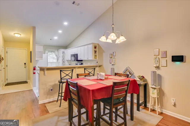 a view of a dining room with furniture and chandelier